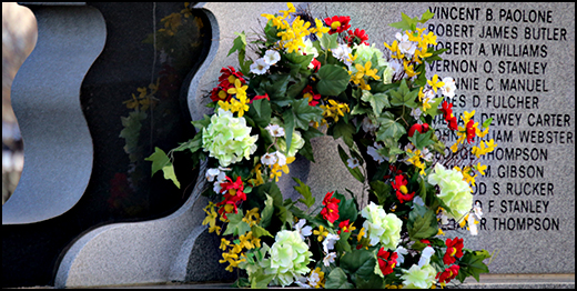 A wreath from the vigil adorns the memorial . . . 